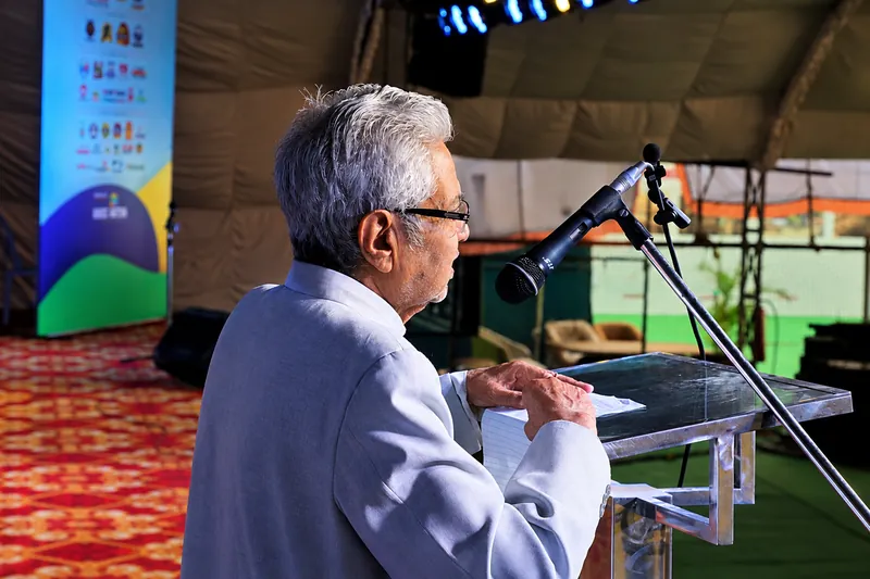 Elderly Speaker at the Podium