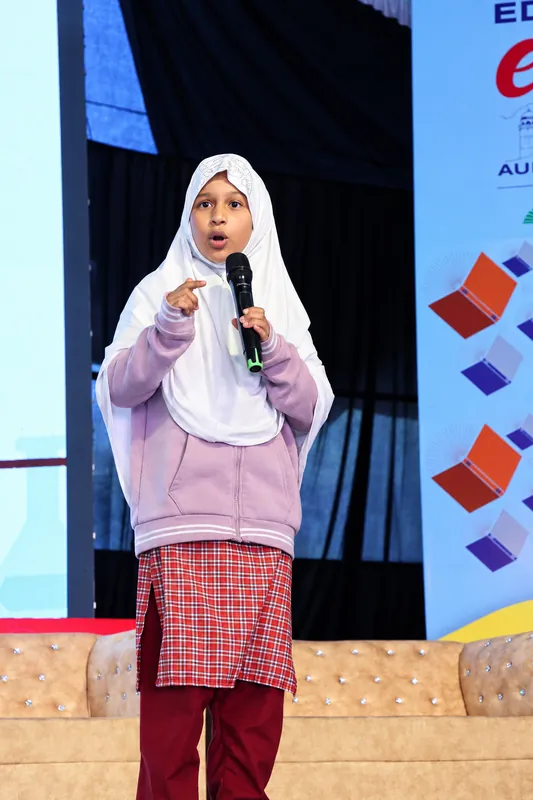 Young Girl Speaking on Stage